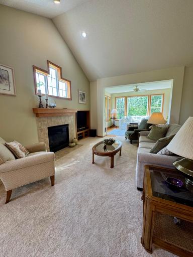 The adjoining living room with vaulted ceilings is spacious and filled with abundant natural light.