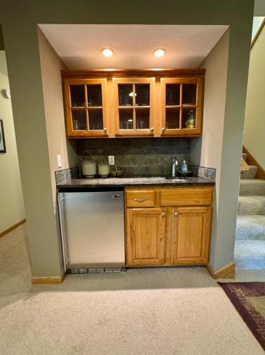 The built-in wet bar with granite counter top makes entertaining fun and easy!