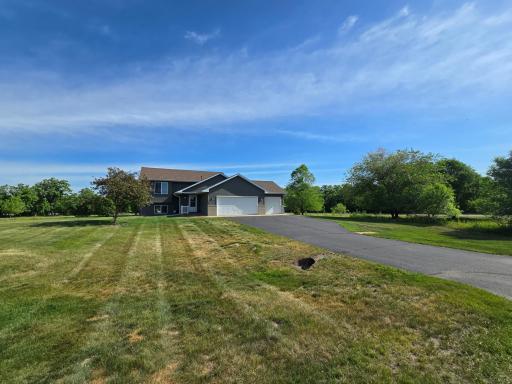 This 3-bedroom, 2-bathroom, split-entry features a heated 3-stall garage, walkout lower level and