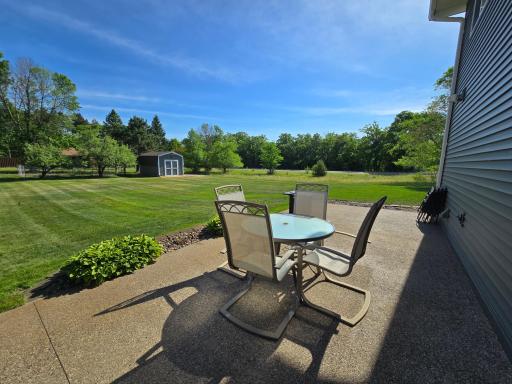 The attractive exposed aggregate finish on the patio blends perfectly with the landscaping in the backyard, offering a natural look to this countryside home.