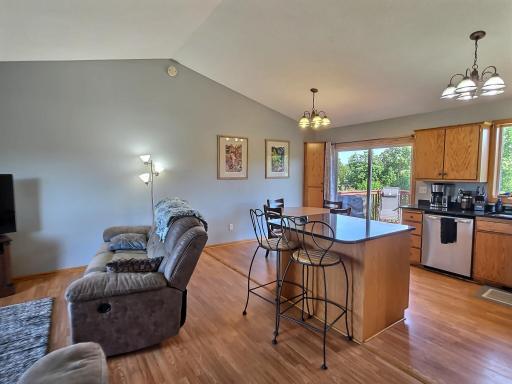 The vaulted upper level is home to the living room, kitchen, and dining area, along with two bedrooms and a full bathroom.