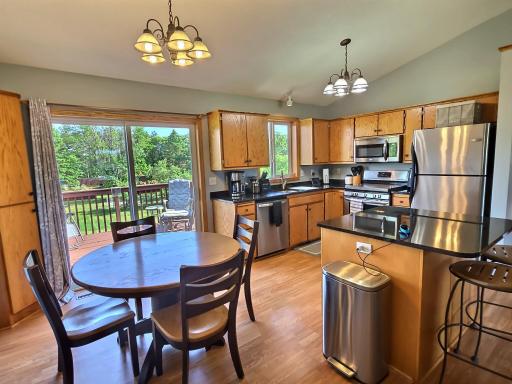 Natural light shines through the large windows and enhances the already appealing kitchen and dining area.