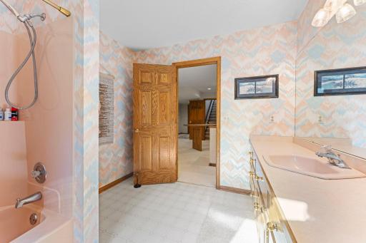 Accessible from each room in the lower level. Complete with the once coveted pink tub and vanity!
