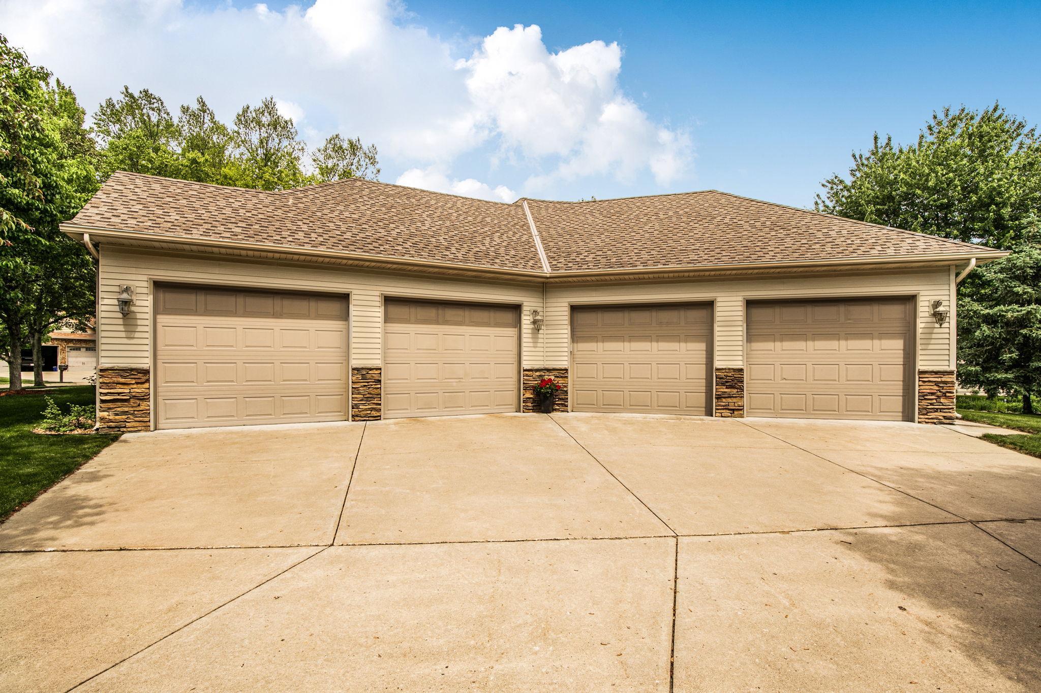 Oversized 4-stall garage with plenty of space for vehicles, tools, and equipment.