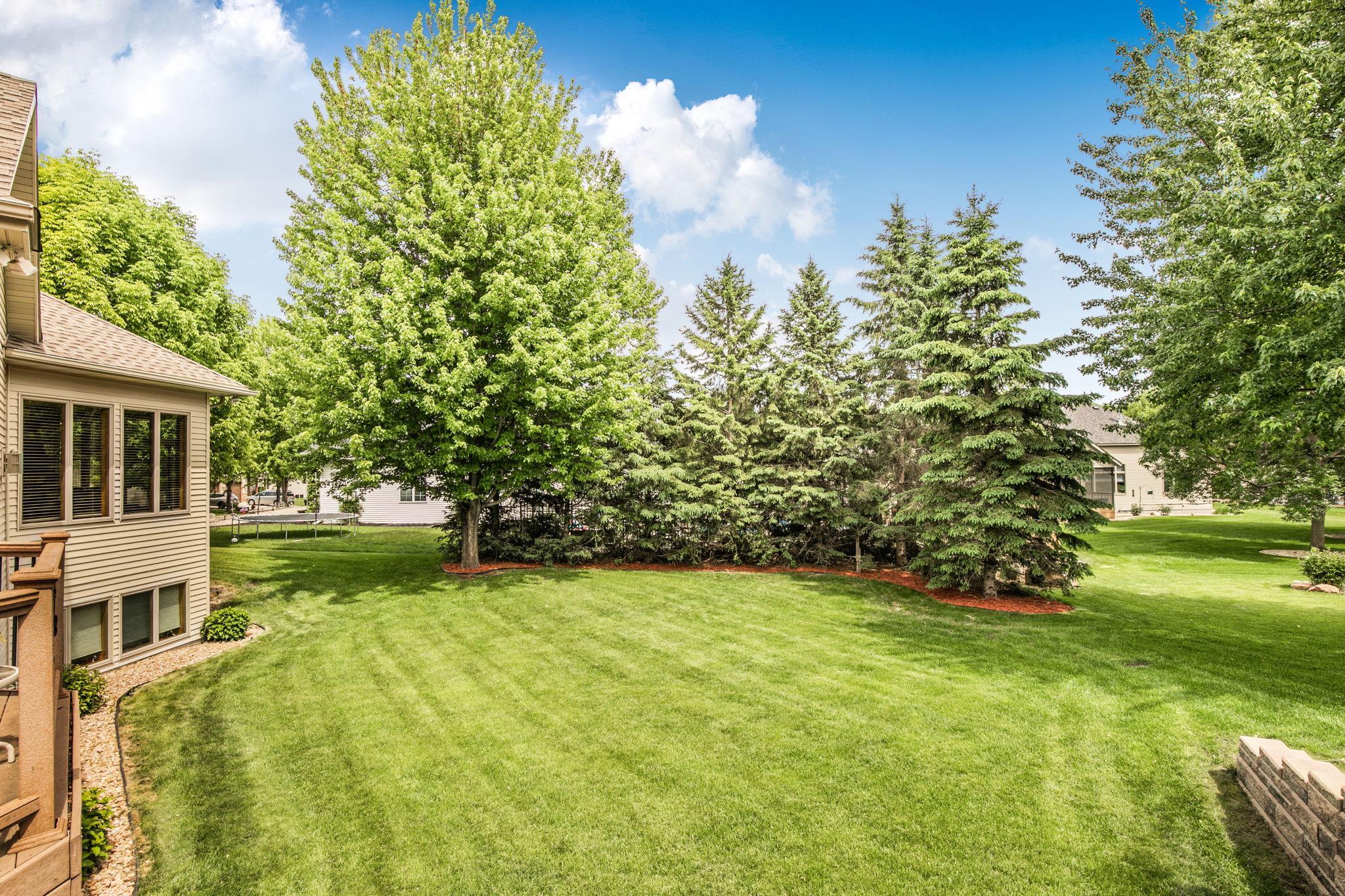 Mature landscaping and trees provide a sense of privacy while enjoying outdoor spaces.