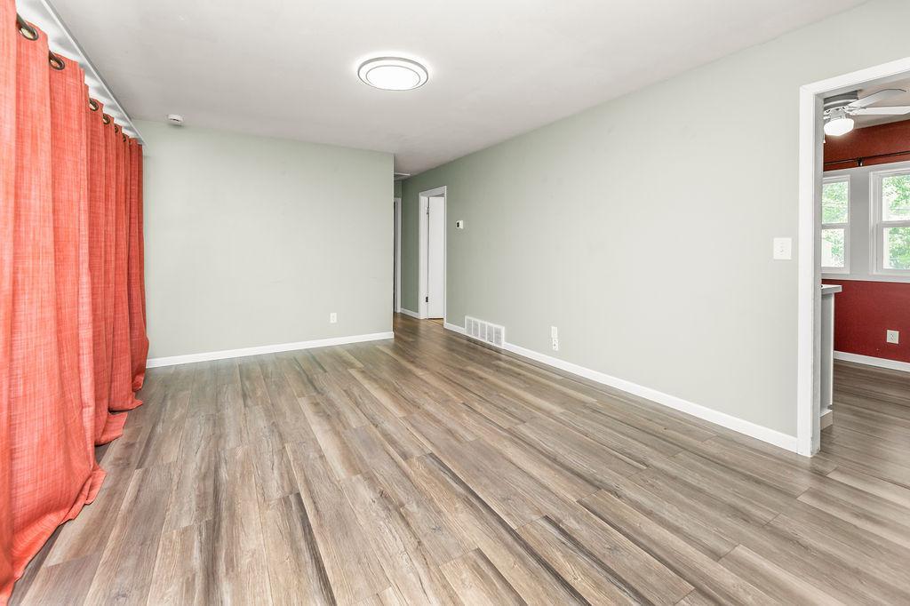 Living Room view to Kitchen & hallway to beds/bath