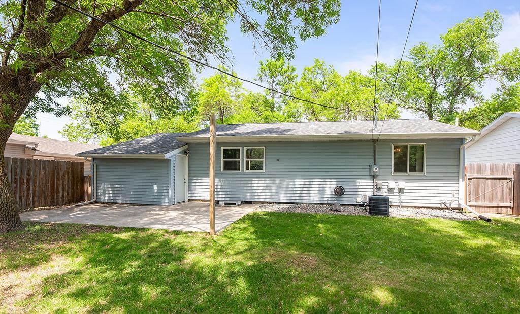 Back of Home w/ concrete patio & garage access