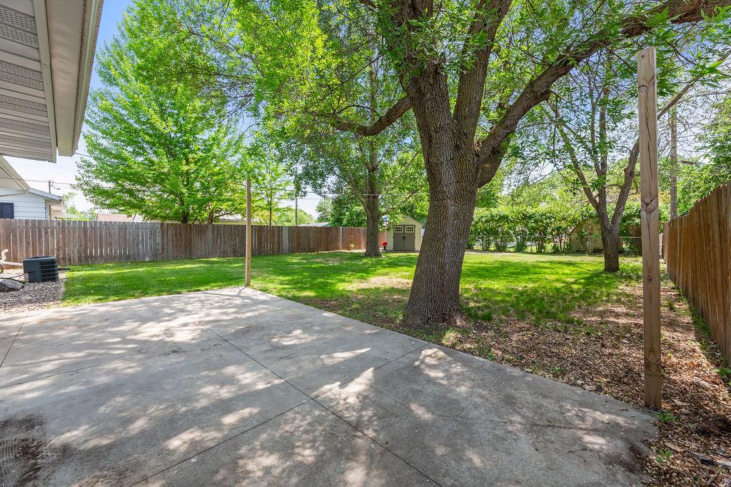 Lovely treed backyard offers space to relax, play & entertain