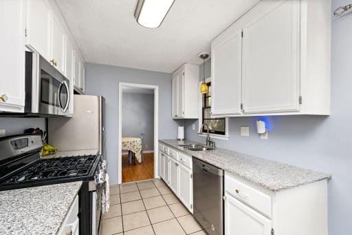 Updated kitchen with SS appliances, granite counters, tile floors, and fresh paint.