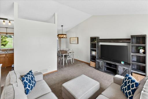 The open flow between the living room and dining area creates a welcoming layout for both entertaining and daily life.