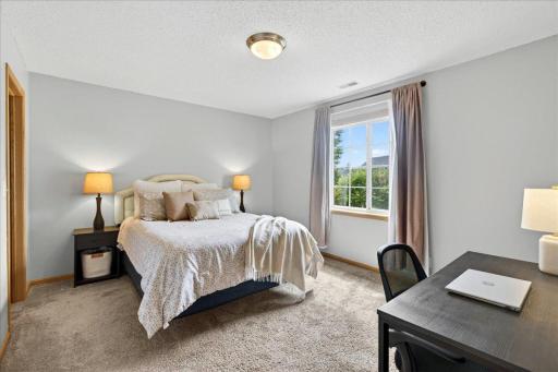 The spacious entry-level bedroom provides a quiet retreat with natural light and flexibility for sleeping, working, or hosting overnight guests.