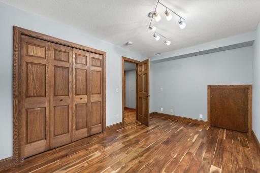 Lower level bedroom is spacious and looks out of gardens.