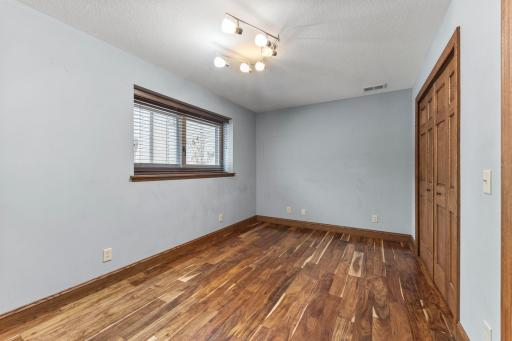 This lower level bedroom offers great views of the trees & perennial gardens