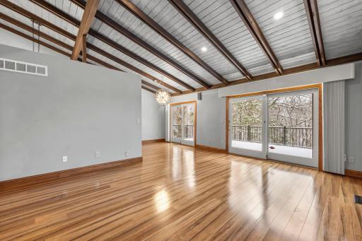Expansive living room with soaring ceilings and peaceful wooded views.