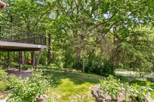 This side and backyard is your own retreat as you are sipping your chai off this back deck or patio