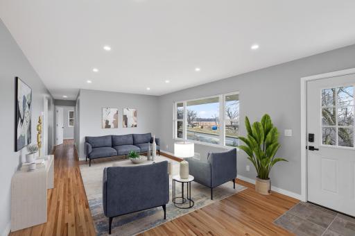 Panoramic views of Marsh Lake Park through the oversized picture window. This image has been virtually staged.