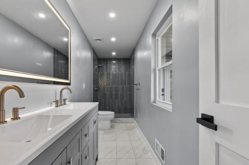 Stunning remodeled bath with dual sinks and step-in shower