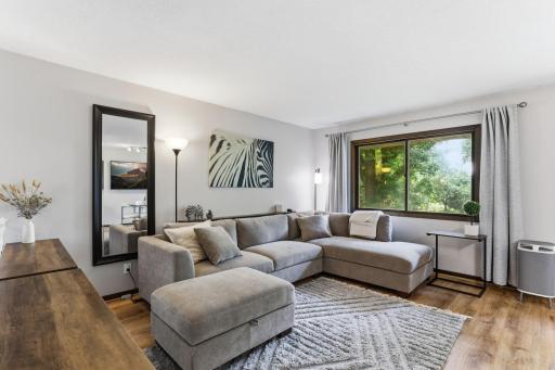 Relaxing living room with newer floor and window treatments.