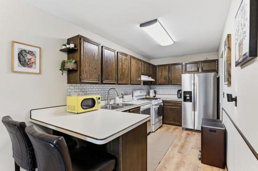 Kitchen has good cupboard space and stainless steel appliances.