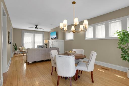 Cozy dining space features charming piano windows and beautifully updated lighting.