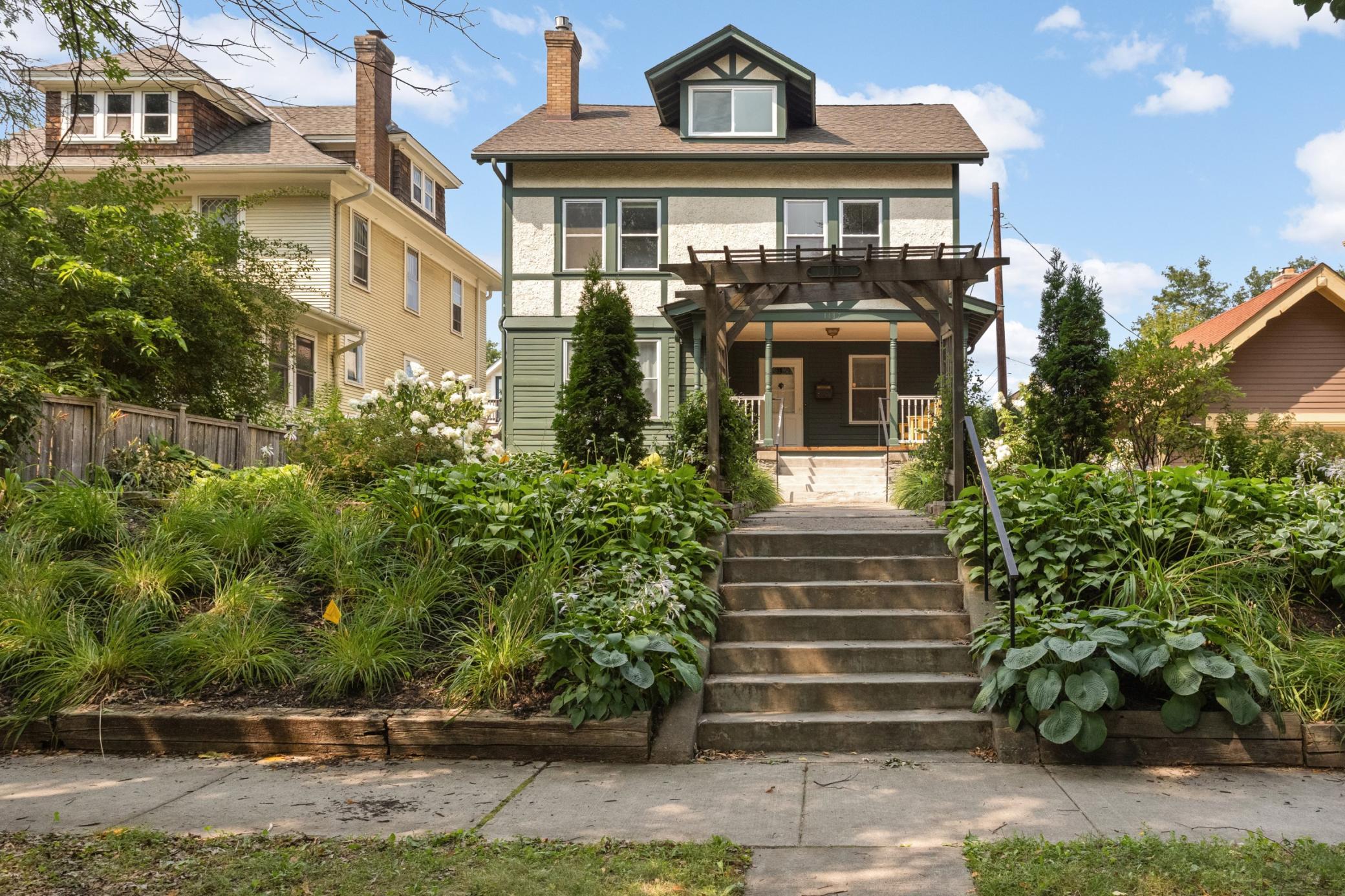 Featuring a charming trellis and mature gardens, this home feels welcoming from the moment you drive up!