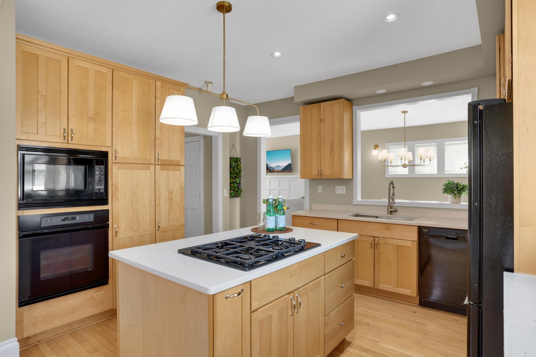 Check out the beautiful kitchen! Custom maple cabinetry throughout and a functional layout that makes cooking and cleanup a breeze! Plenty of space to gather with friends and family in these flexible spaces.