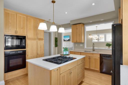 Check out the beautiful kitchen! Custom maple cabinetry throughout and a functional layout that makes cooking and cleanup a breeze! Plenty of space to gather with friends and family in these flexible spaces.