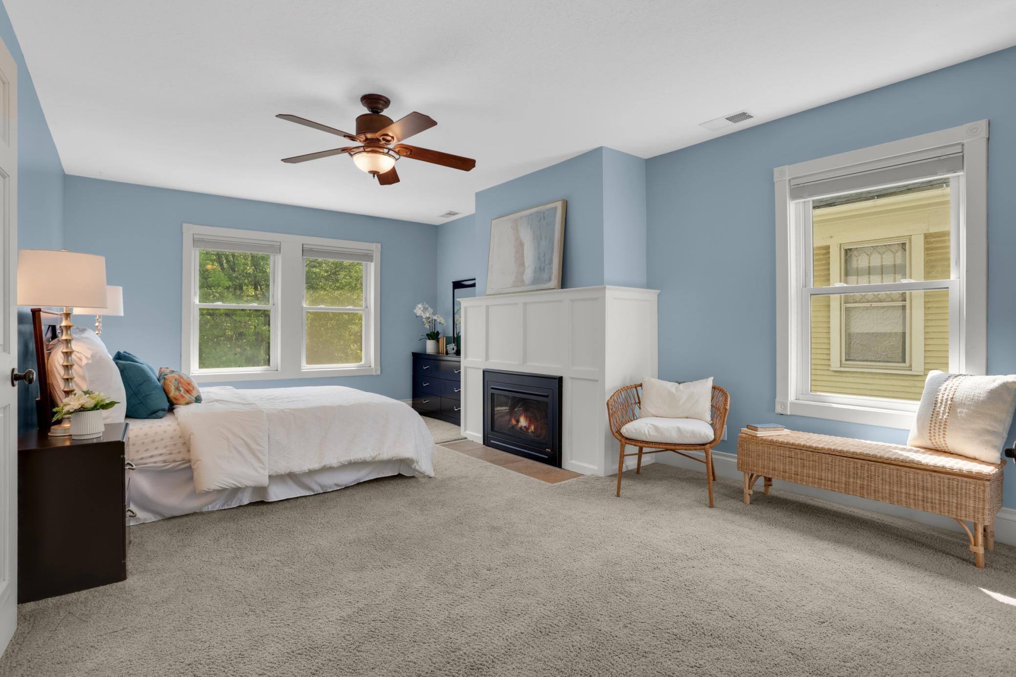 Imagine ending your days in this peaceful primary bedroom, complete with cozy gas fireplace and walk-in closet. Light spills in from all sides.