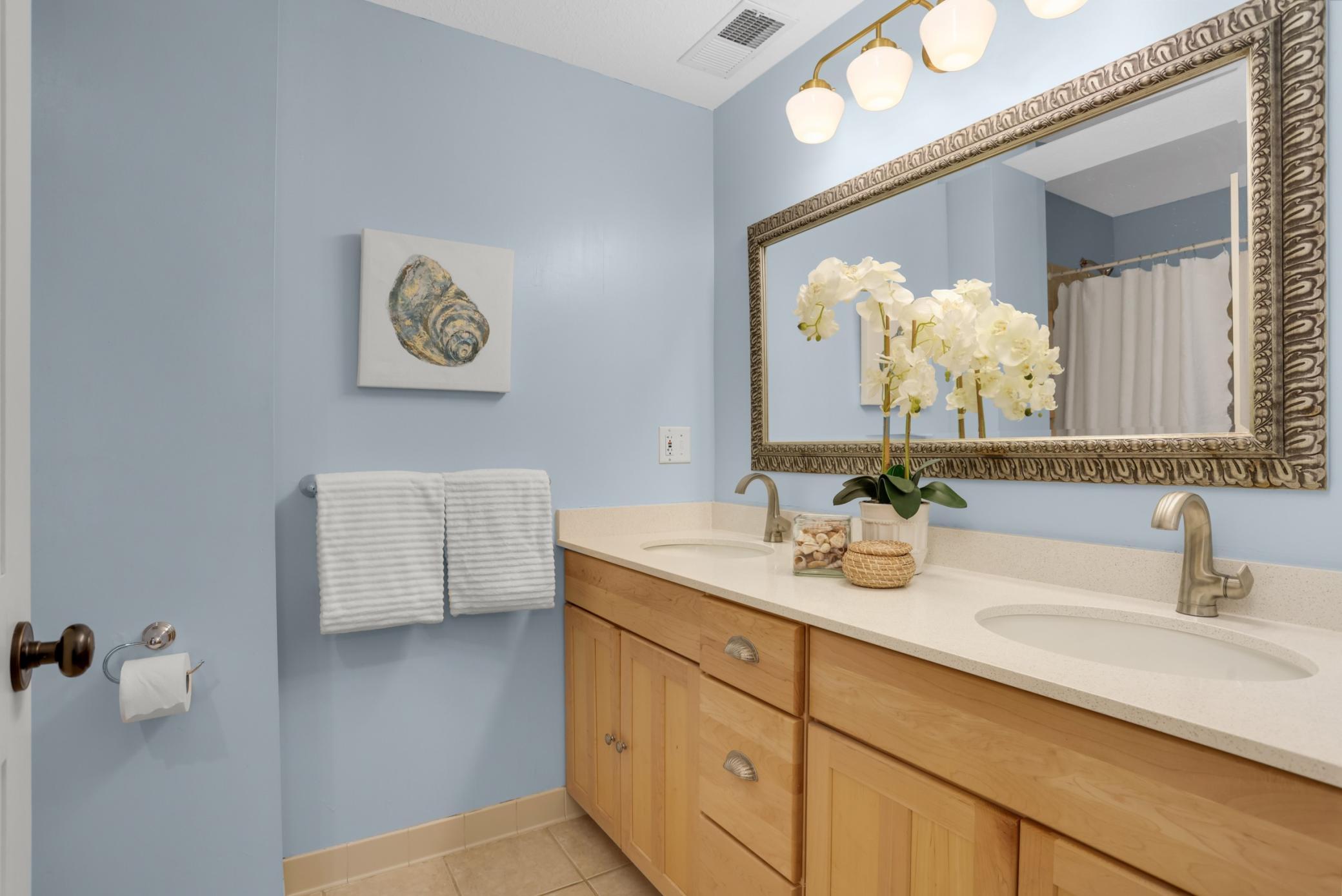 Second floor bathroom conveniently located between primary and second bedroom is generously sized, with dual vanity and oversized tub.