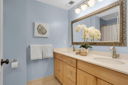 Second floor bathroom conveniently located between primary and second bedroom is generously sized, with dual vanity and oversized tub.