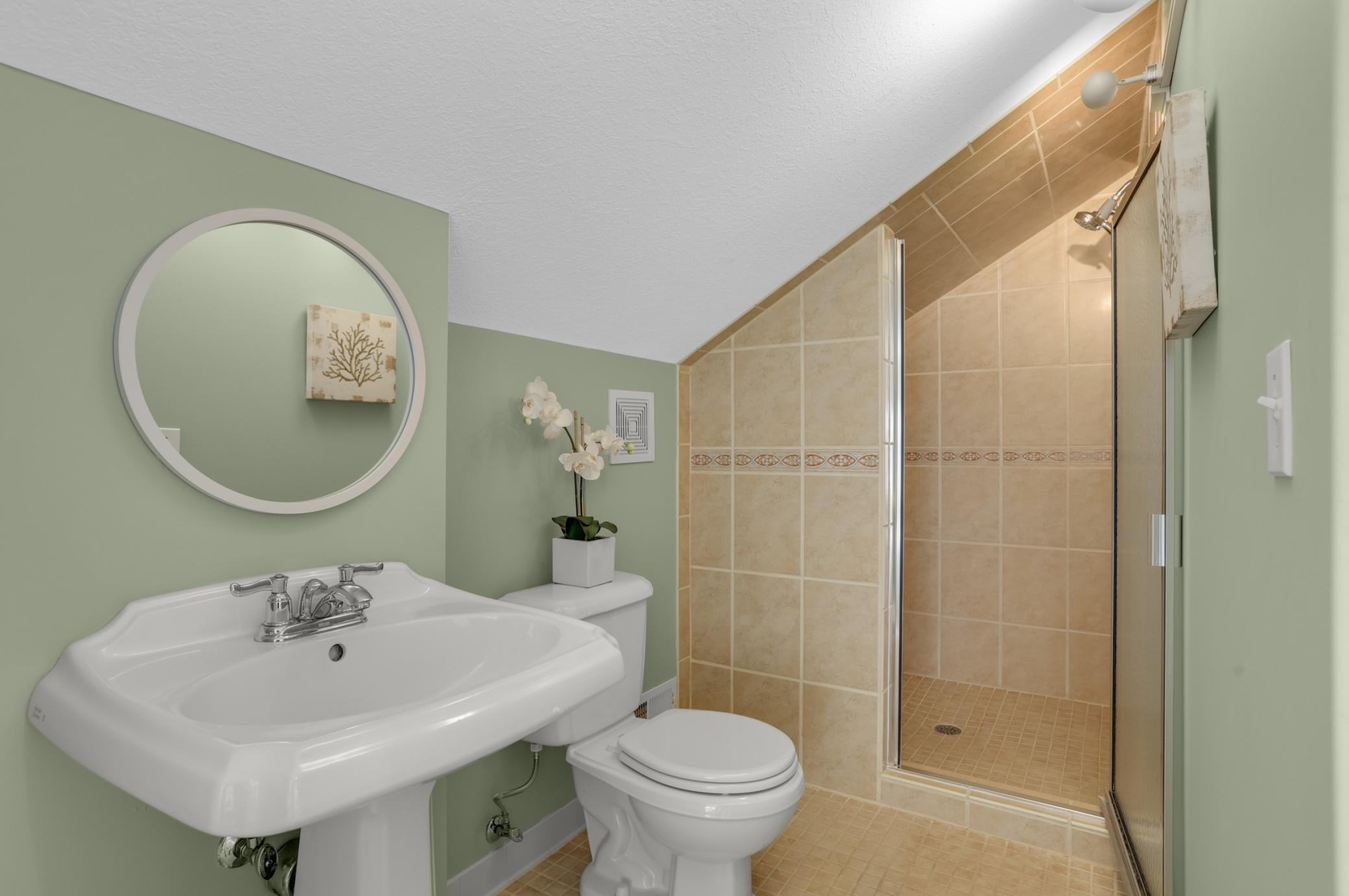 Quaint and functional third floor bathroom offers convenience and privacy from the rest of the home.