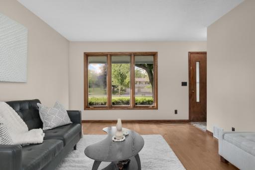 Front windows look out over wide open green space and gardens