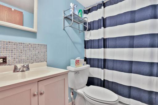 Full bath, shower surround is cracked up high on back side.