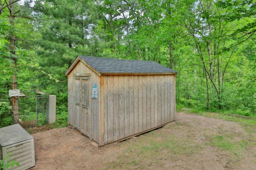 8 x12 Shed, dog kennel just beyond.