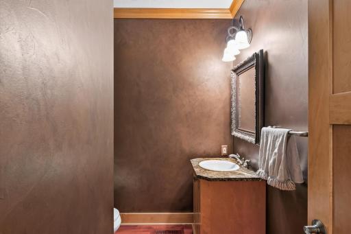 Elegantly appointed, the main-level powder room offers a refined touch for family and guests alike.