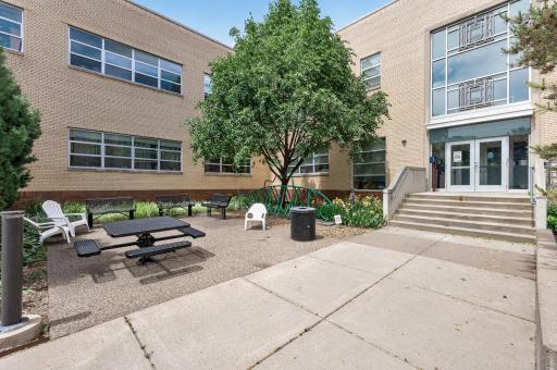 Views of the adjacent outdoor gathering area with the rear entrance other the main building.