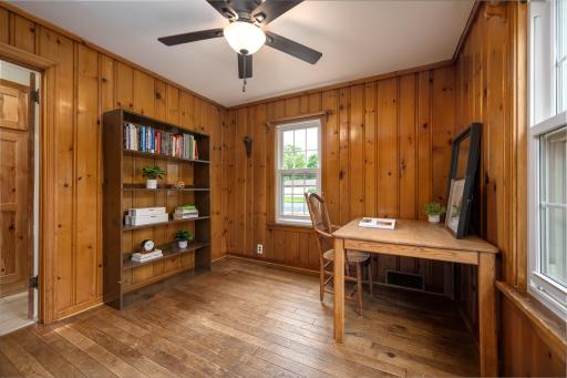 Main level bedroom one perfect for home office.