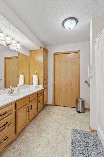 3/4 bath in the primary bedroom, with oversized vanity and large walk-in closet with a window to bring in lots of daylight