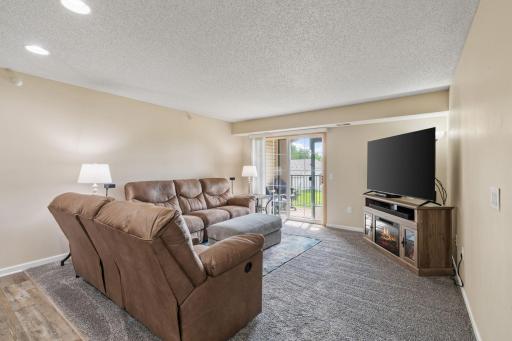 Living room with lots of natural light, great views and access to the covered balcony