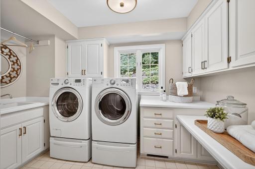 Main Floor Laundry Room with Great Cabinets and Sink Area