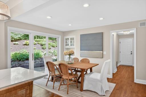 Main Floor Informal Dining with Custom Built-In and Transitions to Outdoor Patio