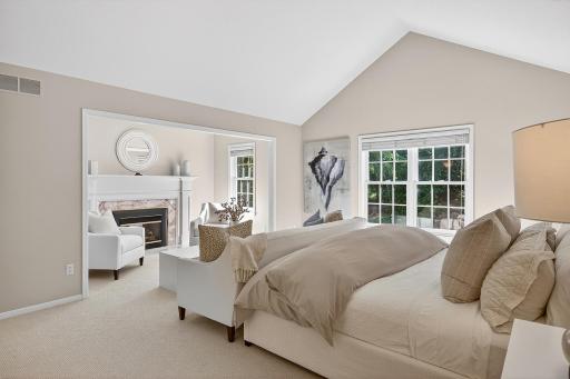 Airy Primary Bedroom with Fireplace and Seating Area