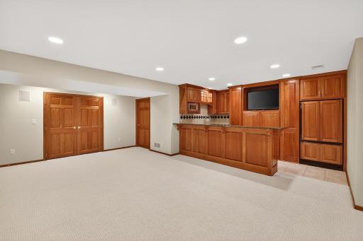 Main Entertaining Room Features Custom Bar with Granite Counters, Cherry Cabinetry - Room for Pool Table. The two large doors lead to storage area.