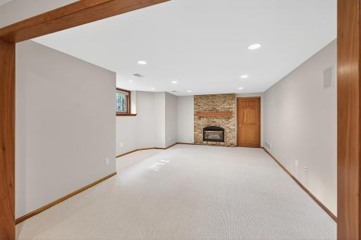 Family Room with Gas Fireplace / The Other Lower Level Room Featured a Pool Table While This Room Featured Seating Areas