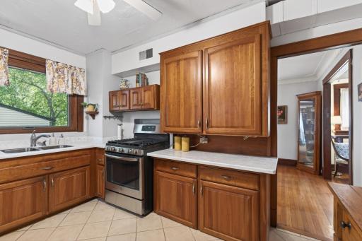 Oversized window above sink overlooks back yard.