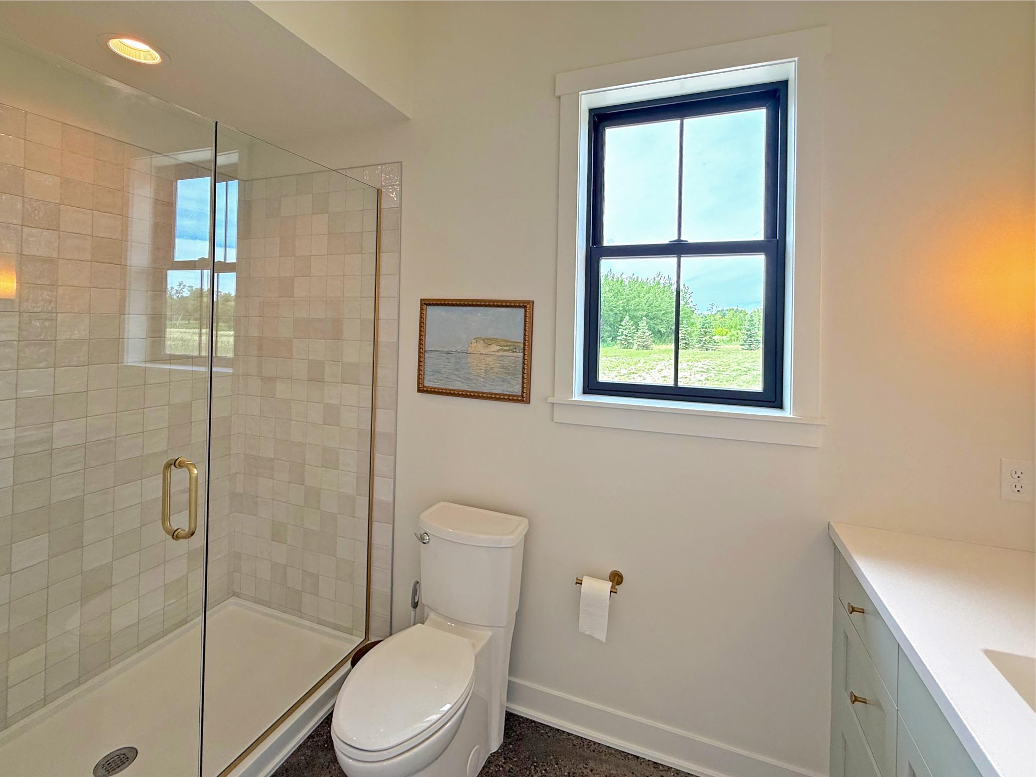 The second bedroom features its own private en-suite bath, offering comfort and convenience for family members or overnight guests.