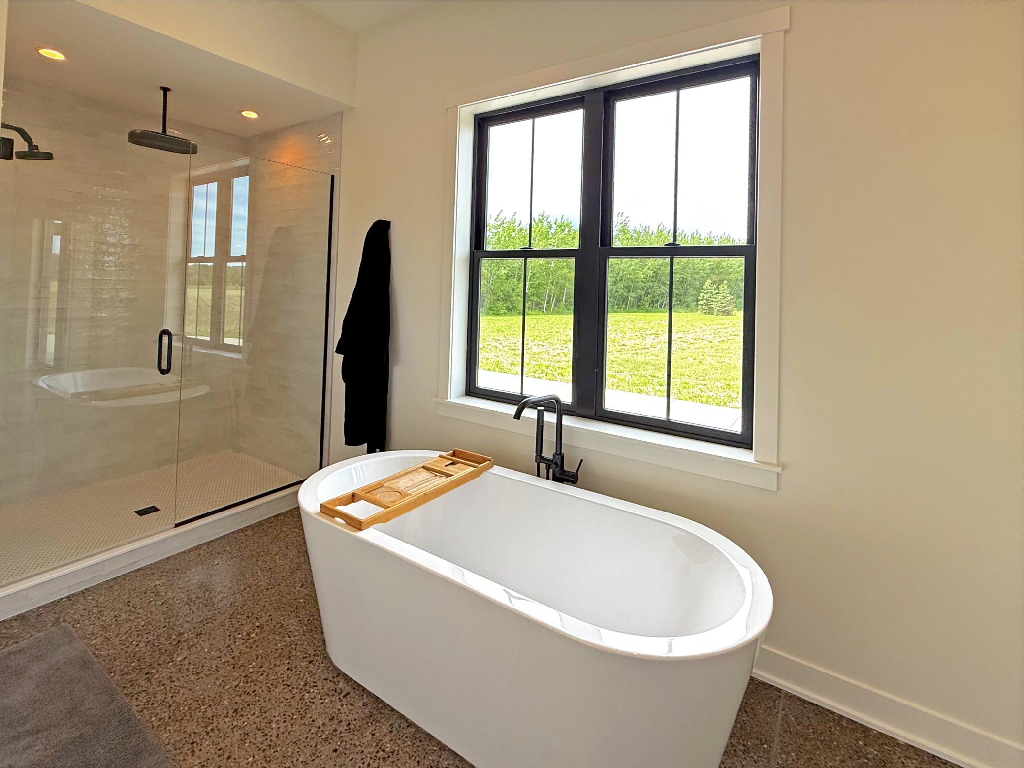 Creating a spa-like atmosphere, the deep soaking tub is the centerpiece of the primary en-suite while a large window creates endless natural light.