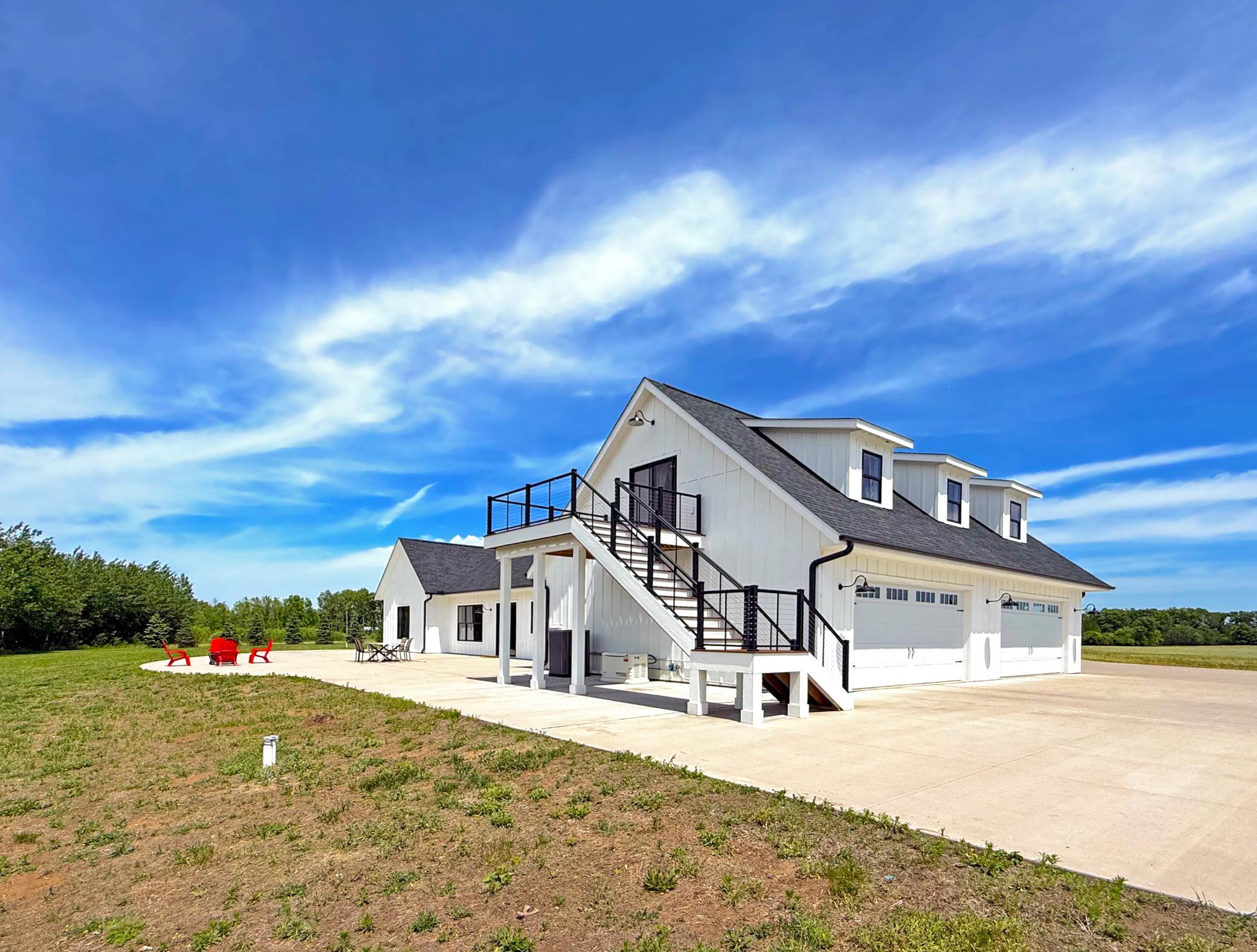 Outside, an extensive concrete apron surrounds the home and attached 4-car garage, providing ample room for vehicles, equipment, and entertaining.
