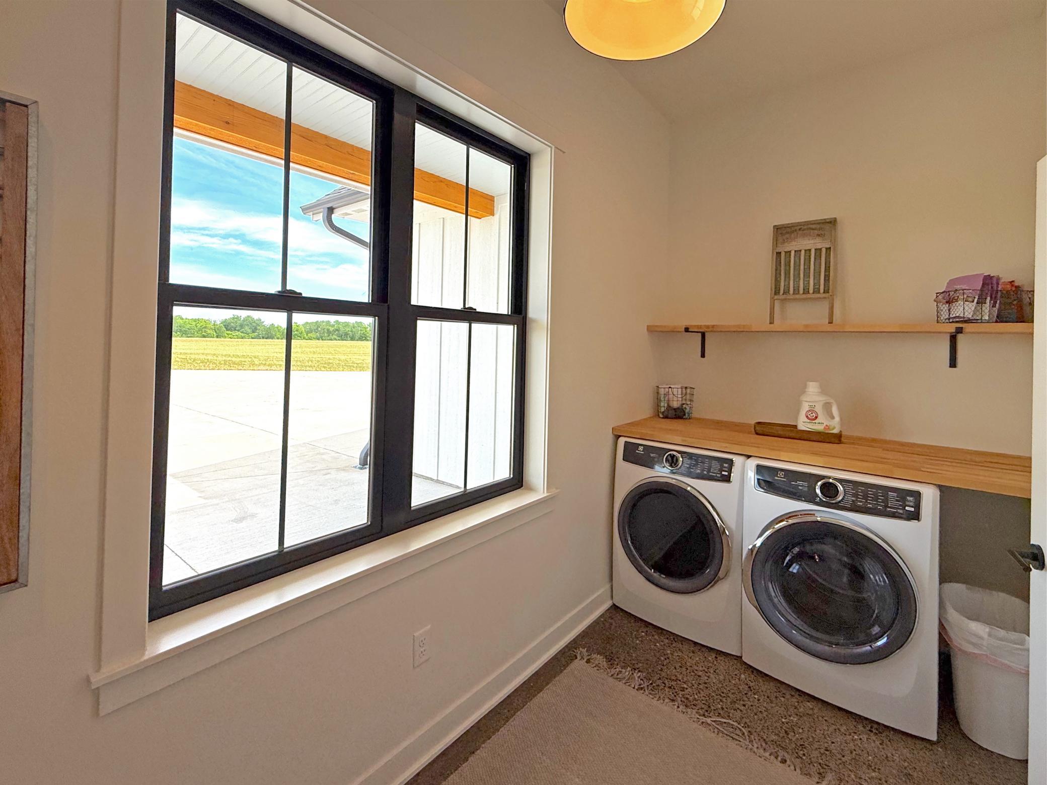 Located just off the main living area, this well-designed space makes daily tasks both efficient and enjoyable, featuring built-in cabinetry and durable countertops.