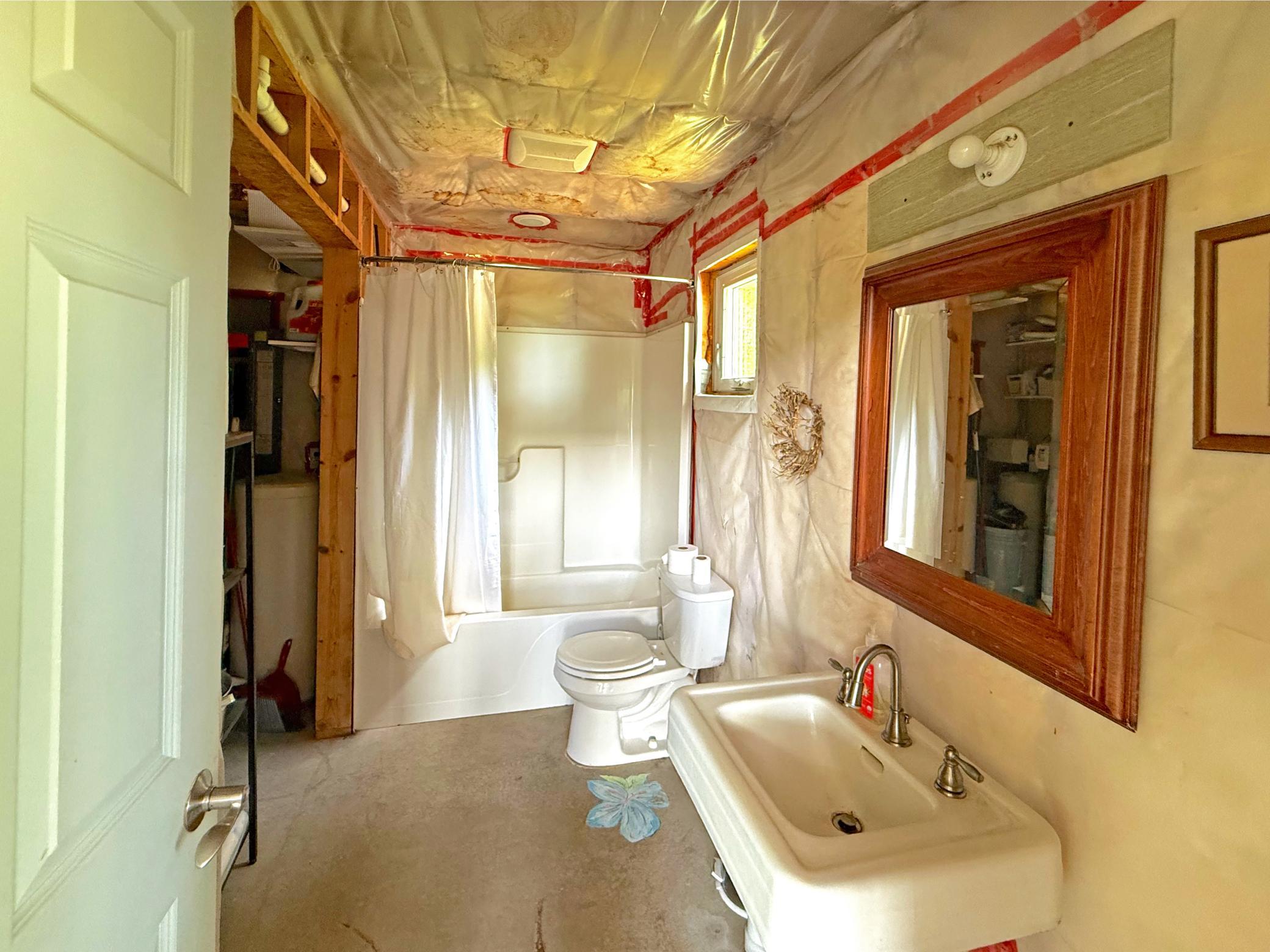 The bathroom is already equipped with a tub/shower combination, vanity, and plumbing fixtures, providing a solid foundation for future completion.